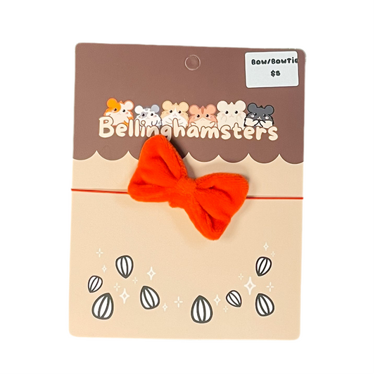 Red bow on a red headband with 'Bellinghamsters' packaging on a white background